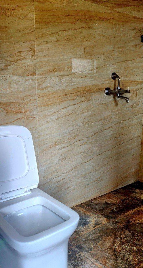 Parvati's Lap Hostel and Villa parvati valley, kasol, Himalayas - Clean and minimal bathroom setup with modern fittings and stone-finish walls, ensuring hygiene and comfort. Perfect for refreshing after long treks in Parvati Valley while maintaining a simple mountain vibe.