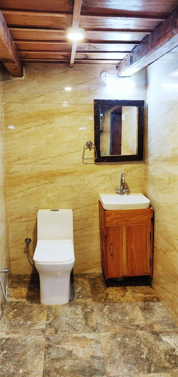 Parvati's Lap Hostel and Villa parvati valley, kasol, Himalayas - Attached bathroom with modern tile finishing ensures hygiene and convenience for guests staying in this wooden-themed dorm.