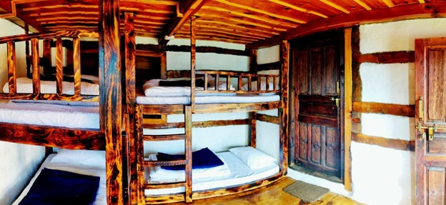 Parvati's Lap Hostel and Villa parvati valley, kasol, Himalayas - Warm ambient lighting and natural wood finishing create a cozy stay experience near the Kheerganga trek route.